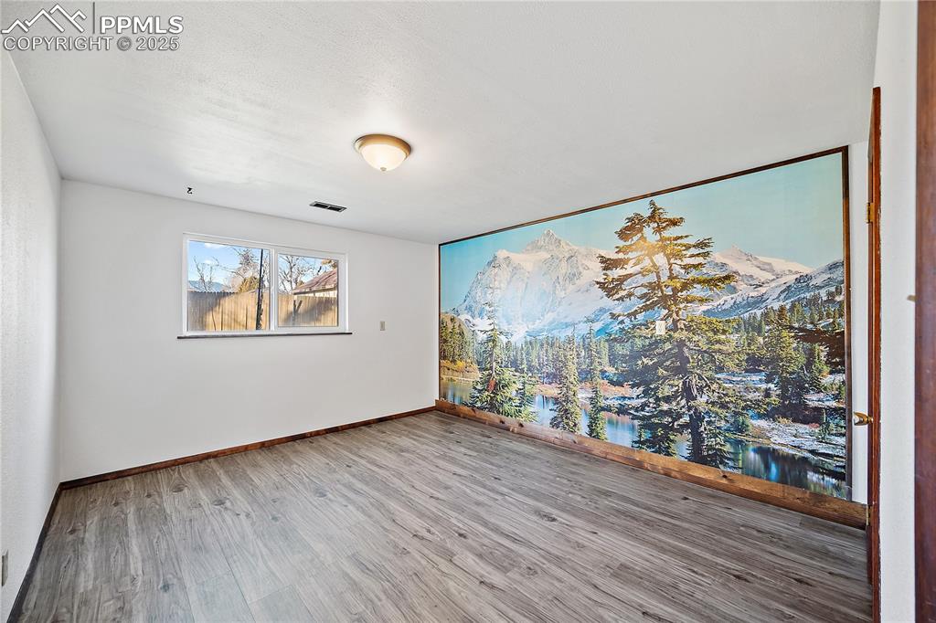 Image 29 of 48: Lower level bedroom 4 with new lvp flooring. 