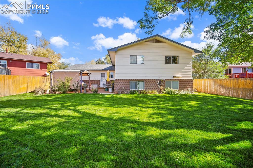 Image 38 of 48: Backyard paradise. Beautiful landscaping, mature trees and gorgeous patio. 