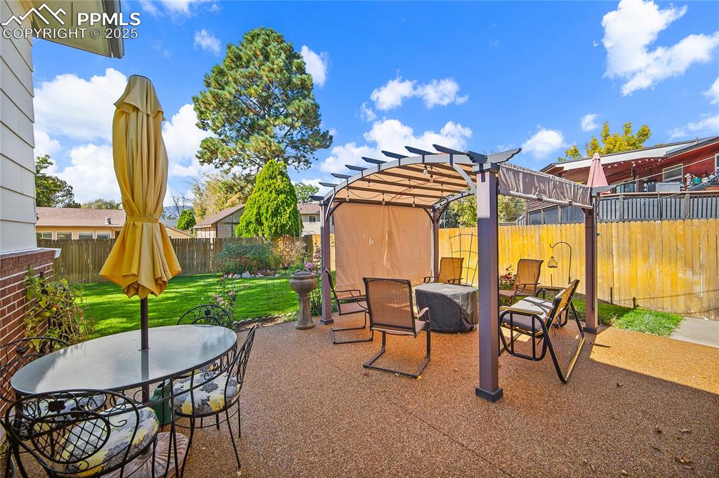 Image 39 of 48: Spacious patio with gazebo. 