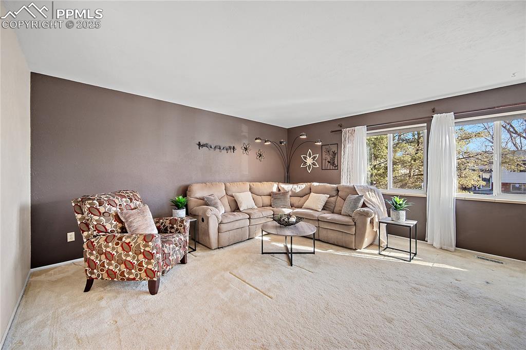 Image 8 of 48: Large picture windows flood the space with natural light.