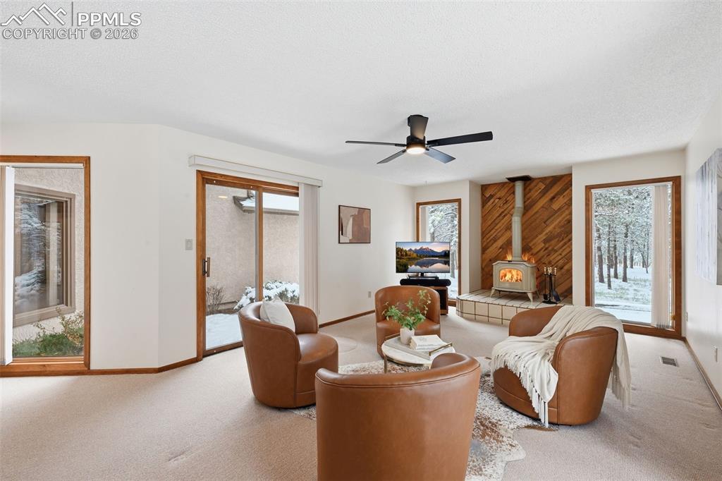 Image 7 of 45: Large family room with wood burning stove and walk out to the courtyard!