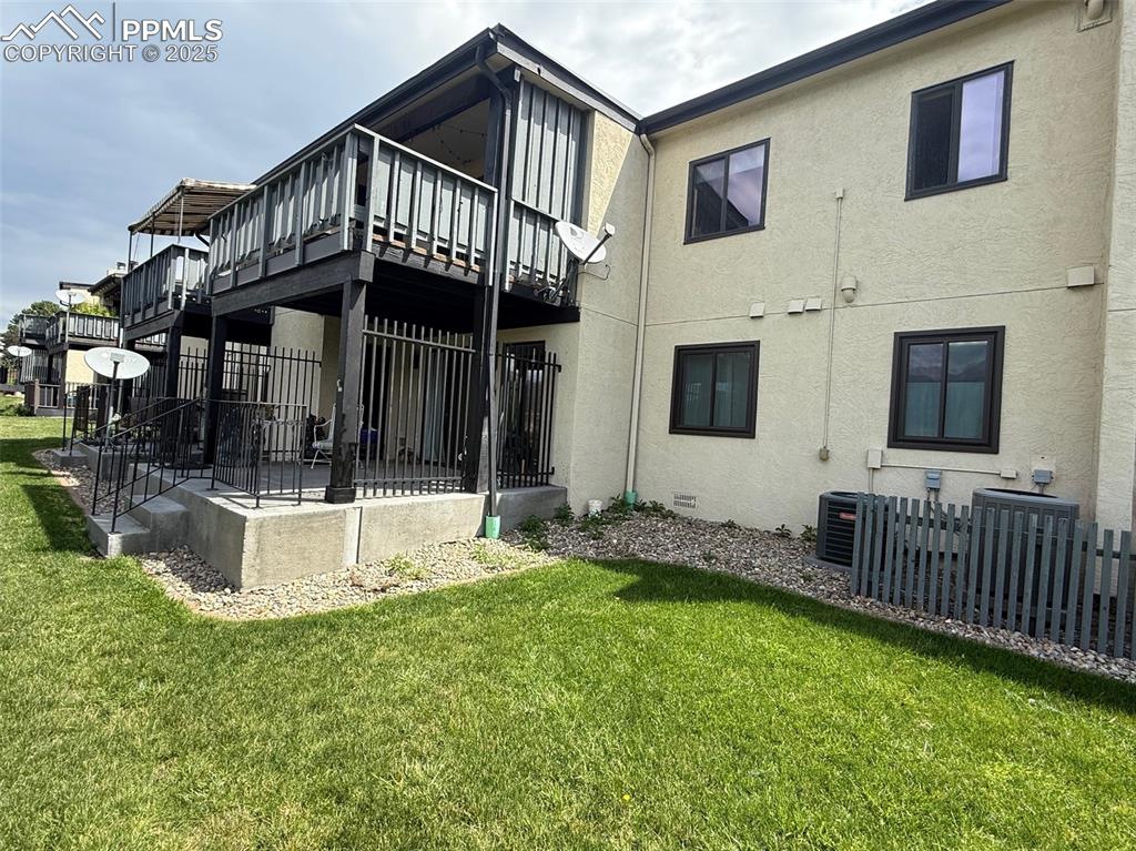 Caption: Back of house featuring stucco siding and covered patio
