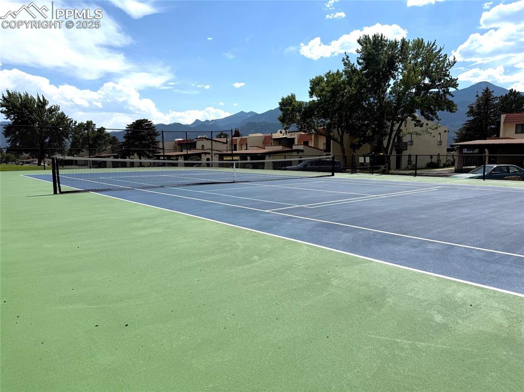 Image 29 of 30: View of tennis court featuring a mountain view