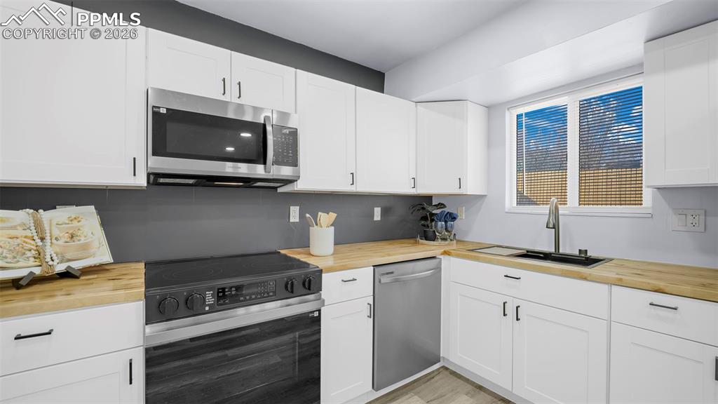 Image 17 of 44: Brand new butcher-block countertops