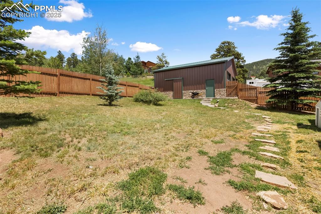 Image 31 of 37: Side view of back yard and detached garage