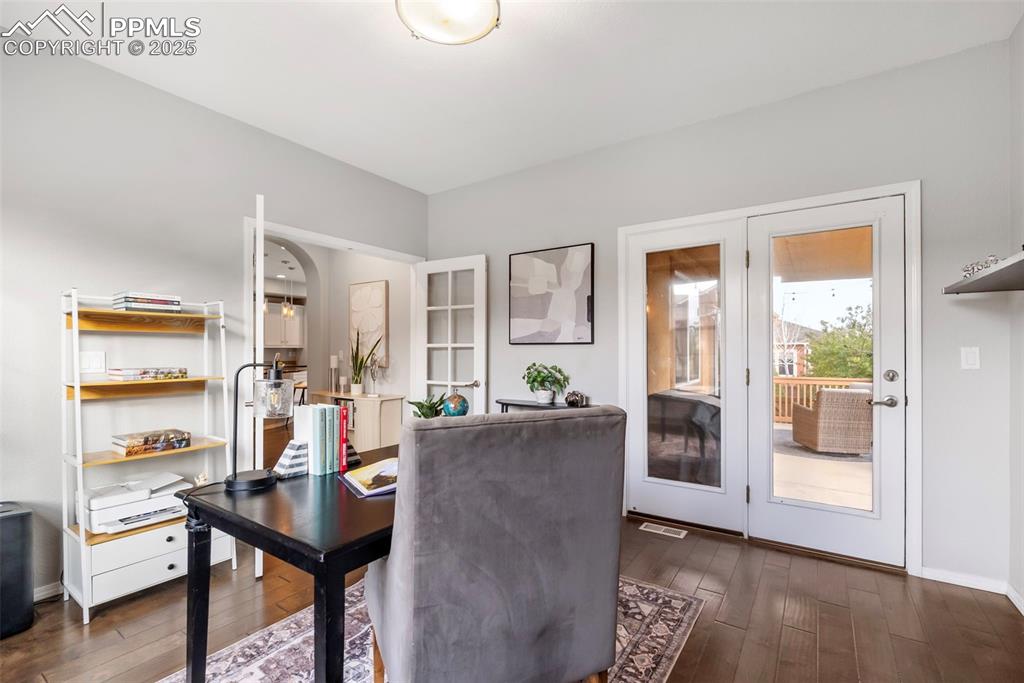 Image 18 of 50: Office featuring baseboards and dark wood-type flooring