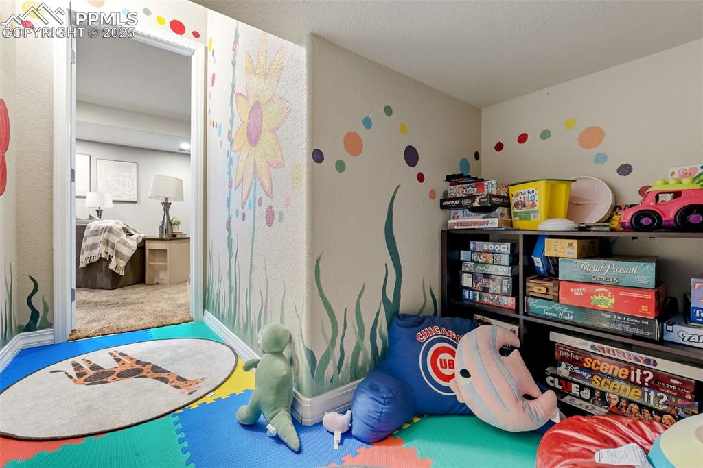 Image 34 of 50: Game room with carpet flooring