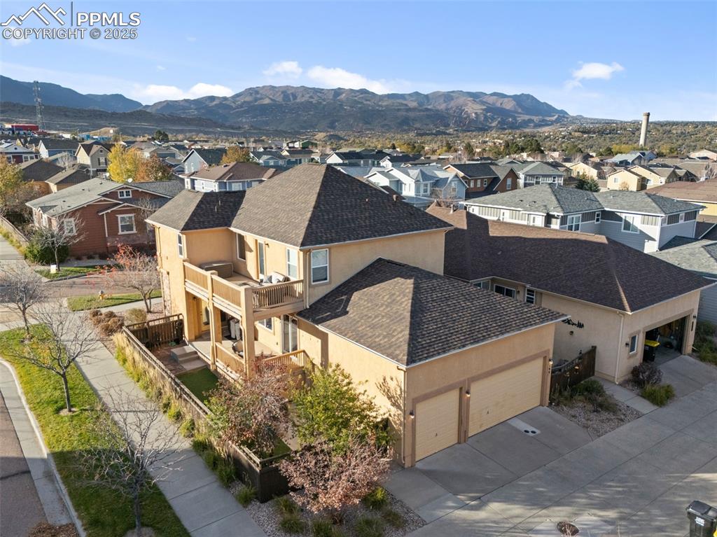 Image 43 of 50: Aerial view of residential area featuring mountains