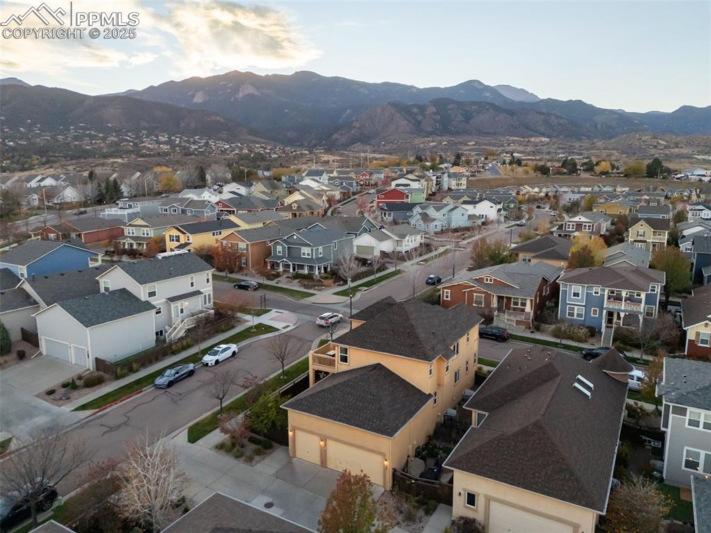 Image 44 of 50: Aerial perspective of suburban area with a mountain backdrop