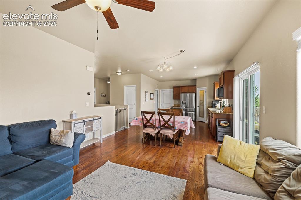 Image 12 of 38: View of the Dining Room and Kitchen from the Living Room.
