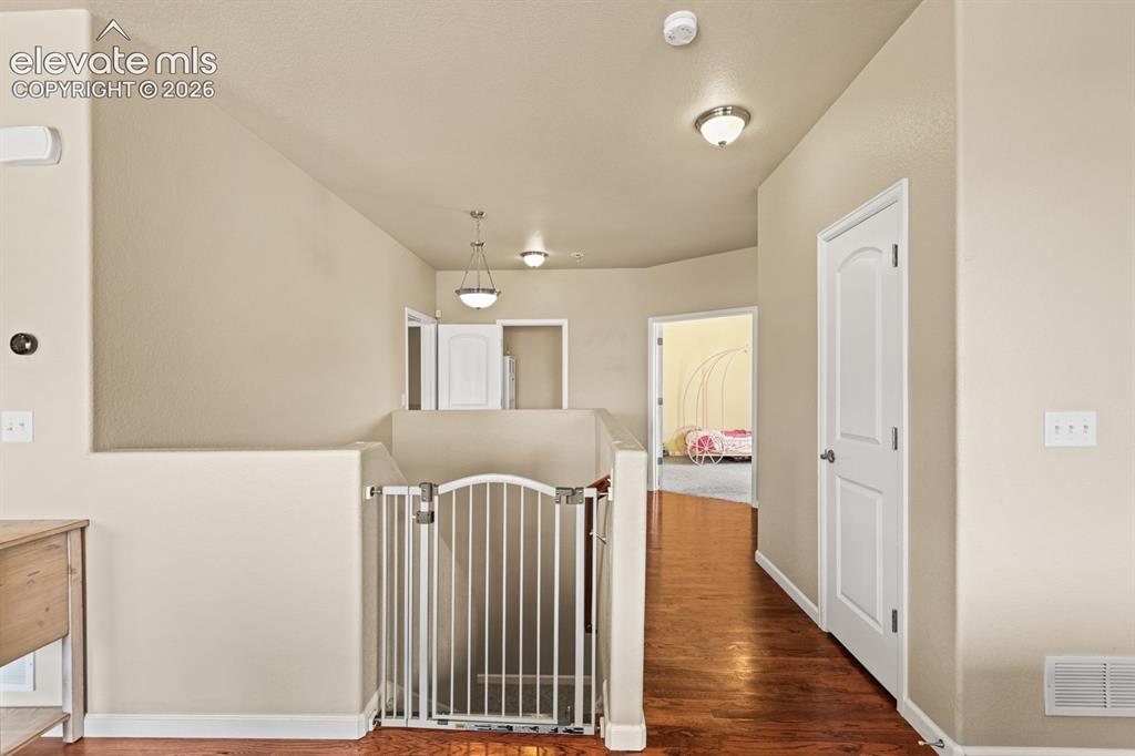 Image 14 of 38: Hallway into the Primary Bedroom.