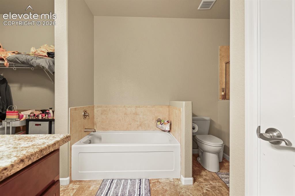 Image 18 of 38: Soaking tub in Primary Bathroom.