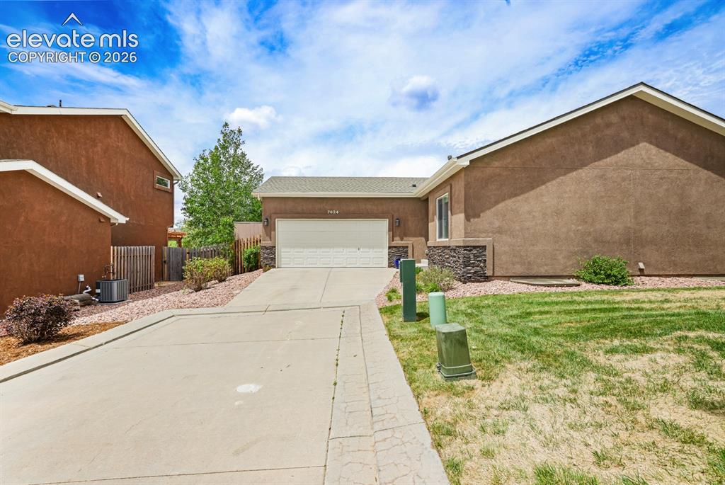 Image 2 of 38: Extended driveway to 2-car attached garage for ample parking.