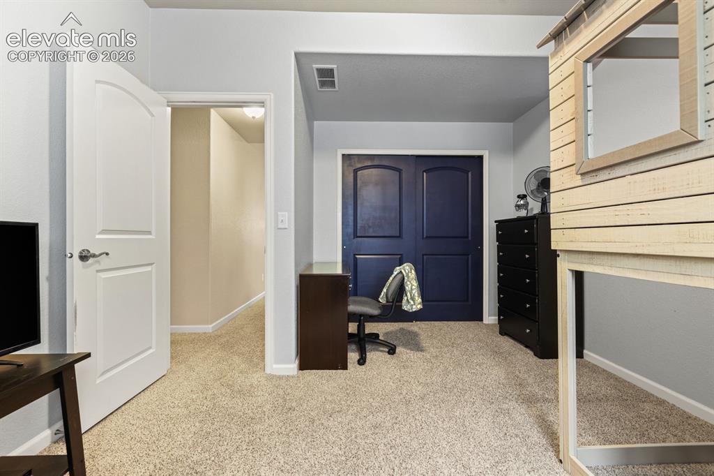 Image 25 of 38: Basement Bedroom #3 with alcove for a desk or play area.