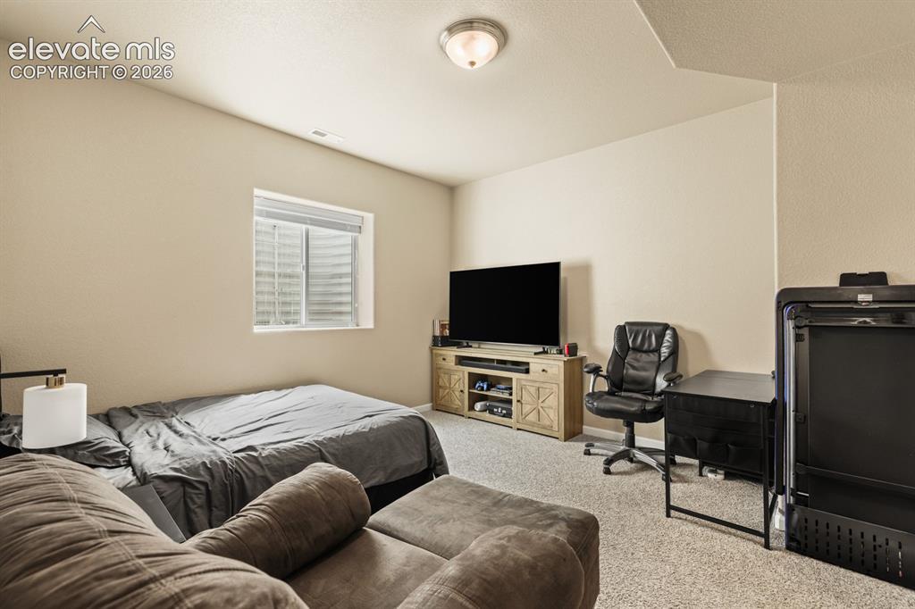 Image 27 of 38: Basement Bedroom #4 with neutral carpet.
