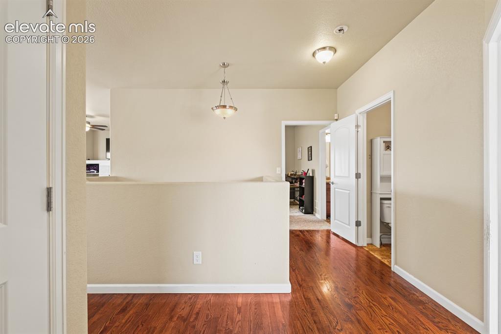 Image 4 of 38: Harwood floors in the hallway.