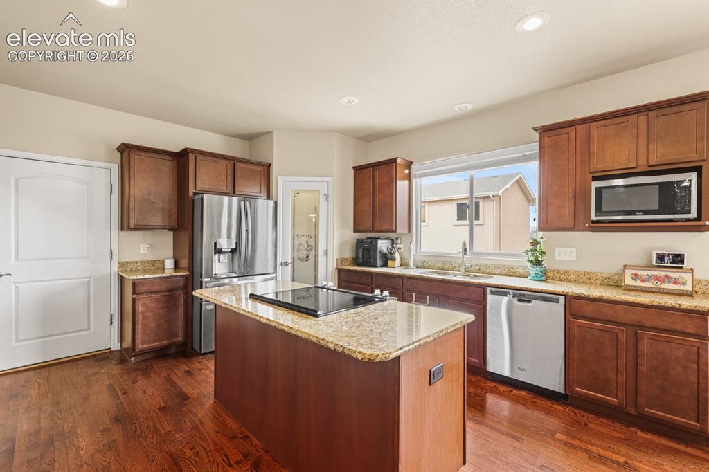 Image 8 of 38: Island Kitchen with breakfast bar, pantry, wood cabinets with granite count