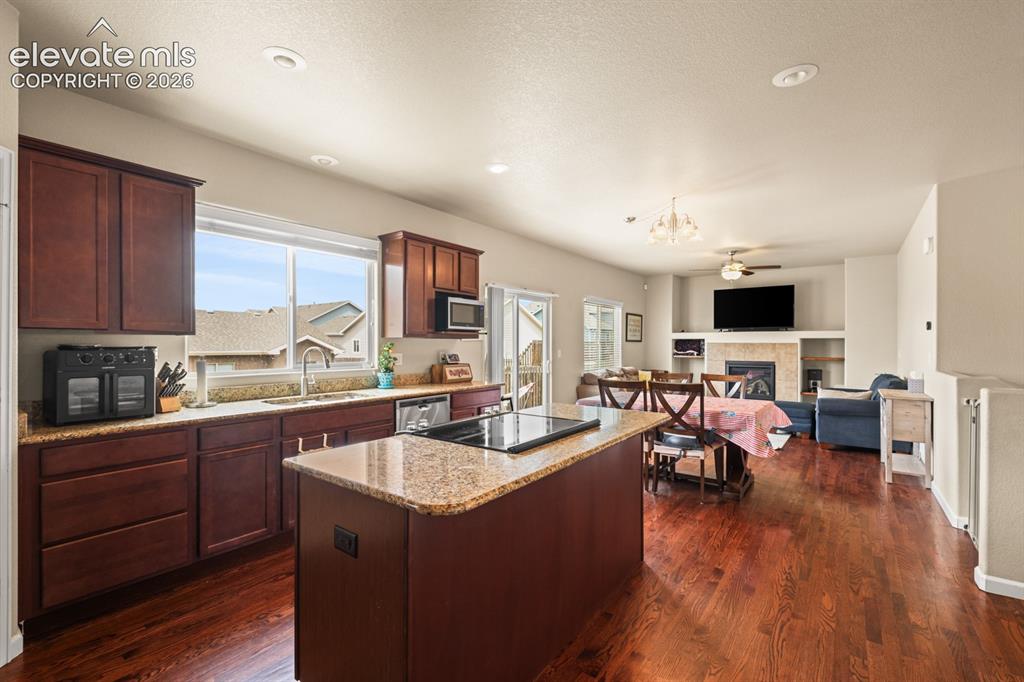 Image 9 of 38: View of the Dining Room and Living Room from the Kitchen.