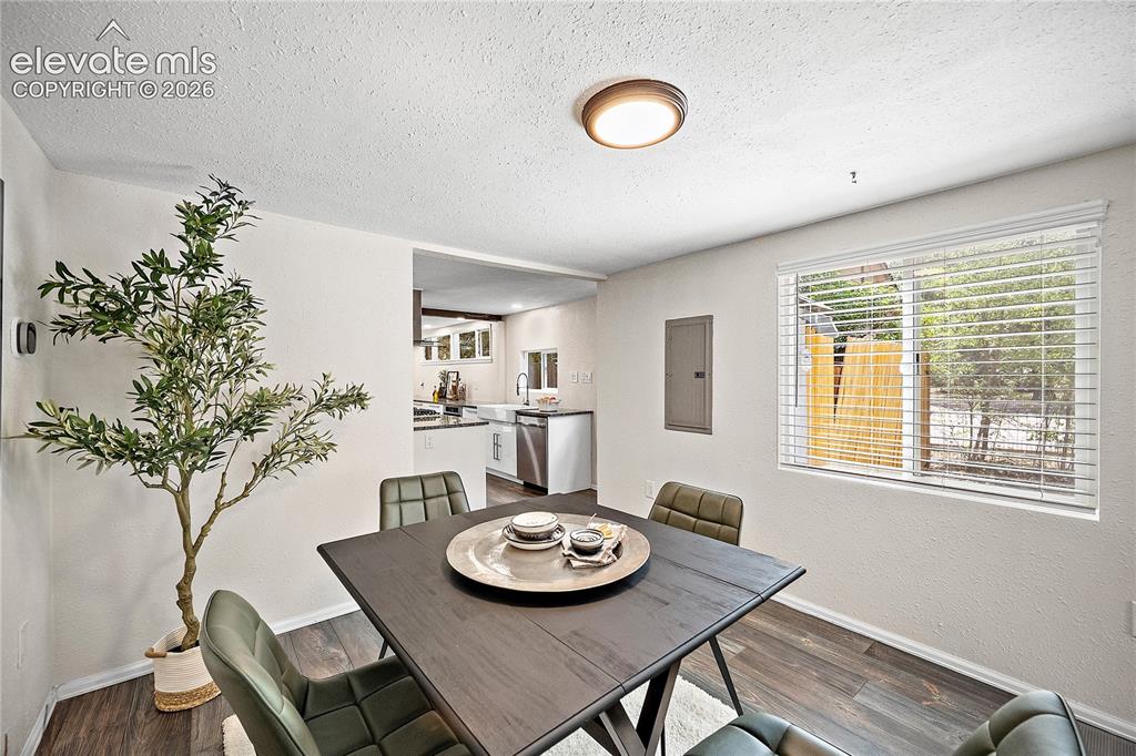 Image 11 of 41: Dining area featuring wood-finish flooring and a window with blinds