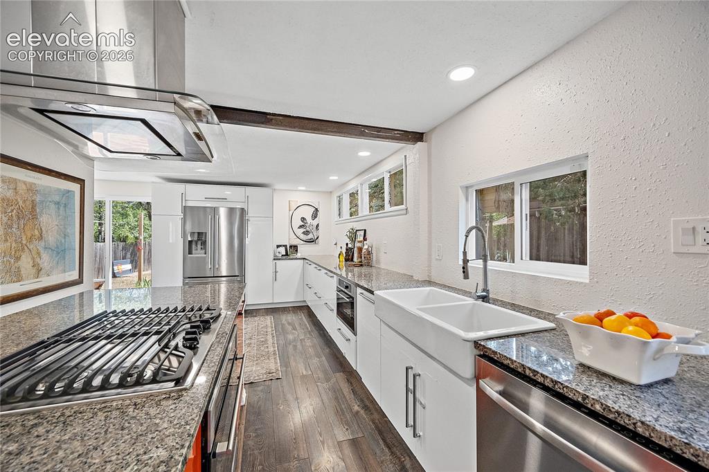 Image 19 of 41: Modern kitchen featuring stainless steel appliances, granite countertops, w