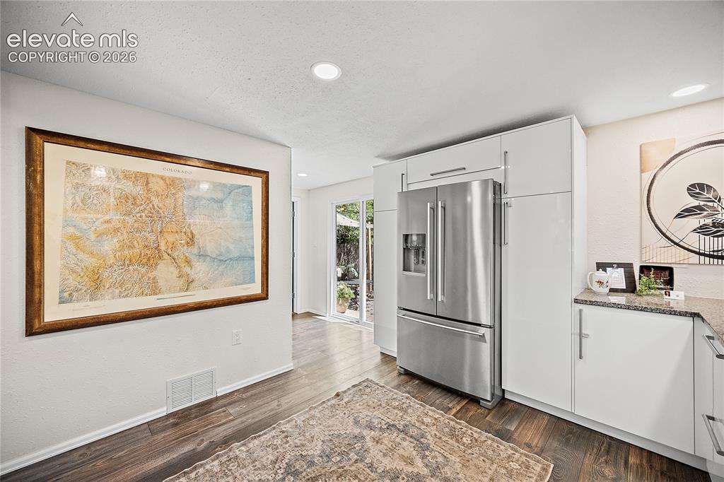 Image 21 of 41: Kitchen area featuring wood-finish flooring, recessed lighting, white cabin
