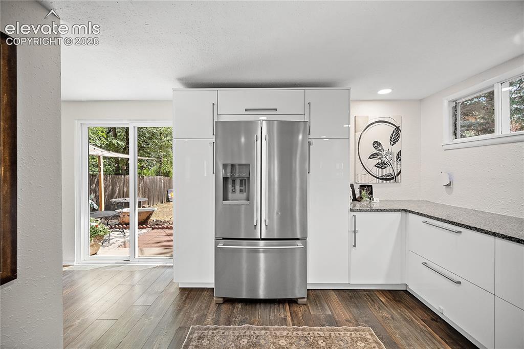 Image 22 of 41: Contemporary kitchen featuring a stainless steel French-door refrigerator,