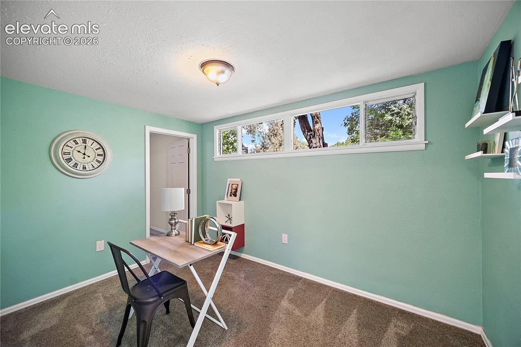 Image 26 of 41: Room featuring a textured ceiling, a flush-mount light fixture, and light g