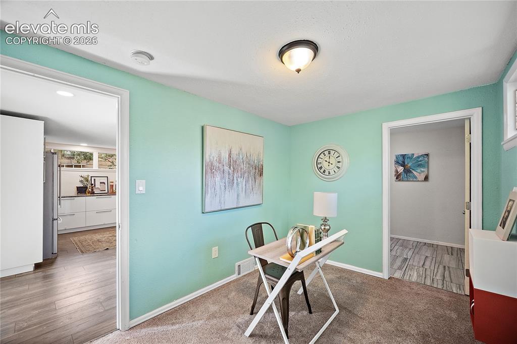 Image 27 of 41: Interior room featuring light teal walls, carpet flooring, and a semi-flush