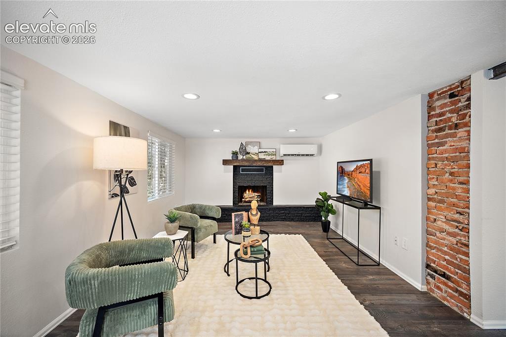 Image 6 of 41: Living space featuring dark wood-finish flooring, recessed lighting, and wh