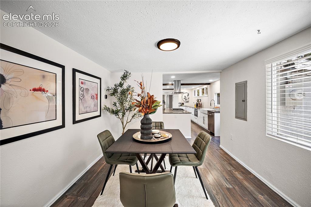 Image 9 of 41: Dining area featuring wood-finish flooring and a contemporary flush-mount c