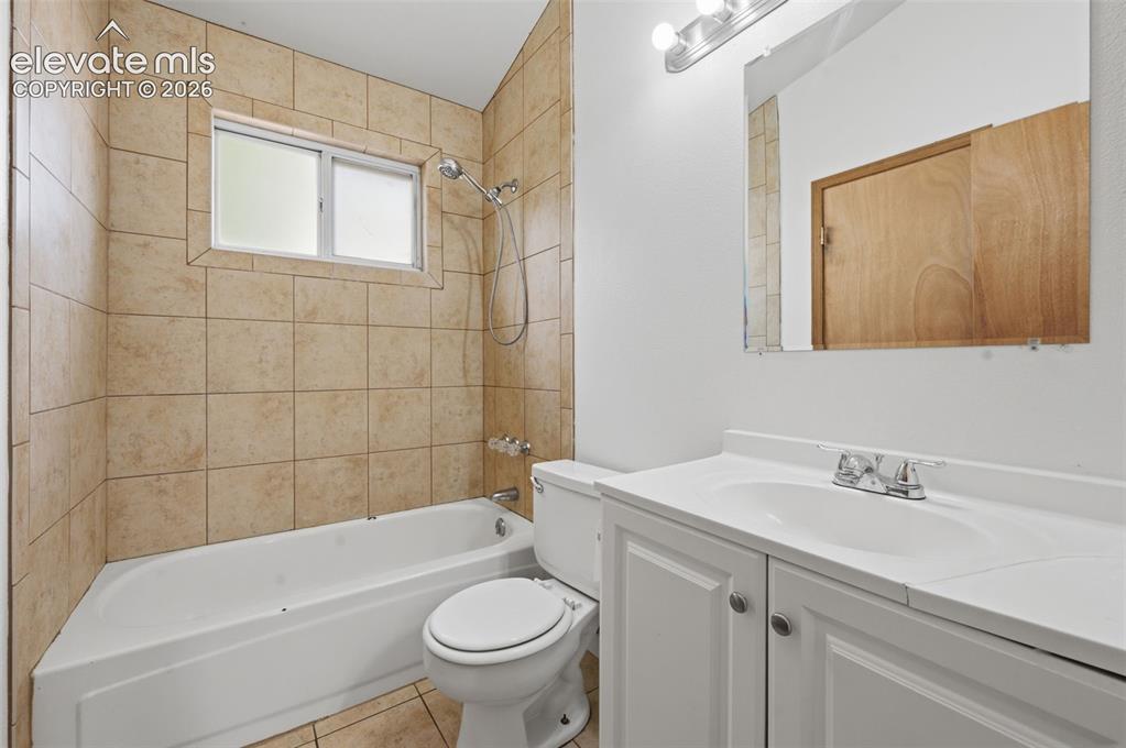 Image 13 of 29: Bathroom featuring a white vanity with a single basin sink and chrome fauce