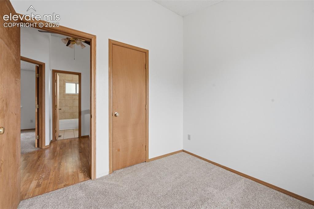 Image 17 of 29: Office/3rd main level bedroom. Carpeted room featuring white walls, light w