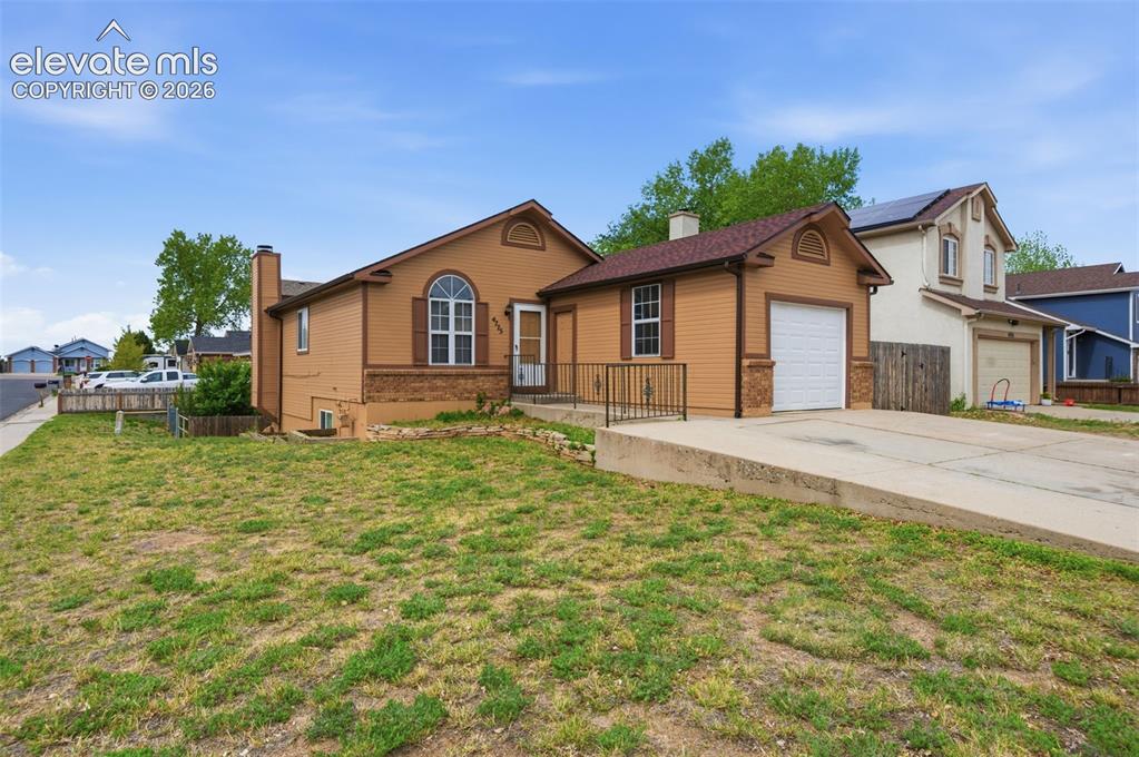 Image 2 of 29: Siding exterior with a prominent arched window, attached garage, and a conc