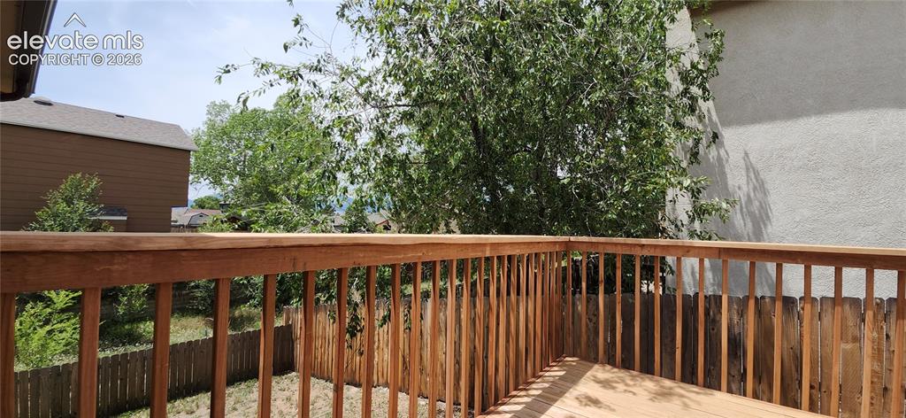 Image 26 of 29: Wood deck featuring a natural finish and slatted railing