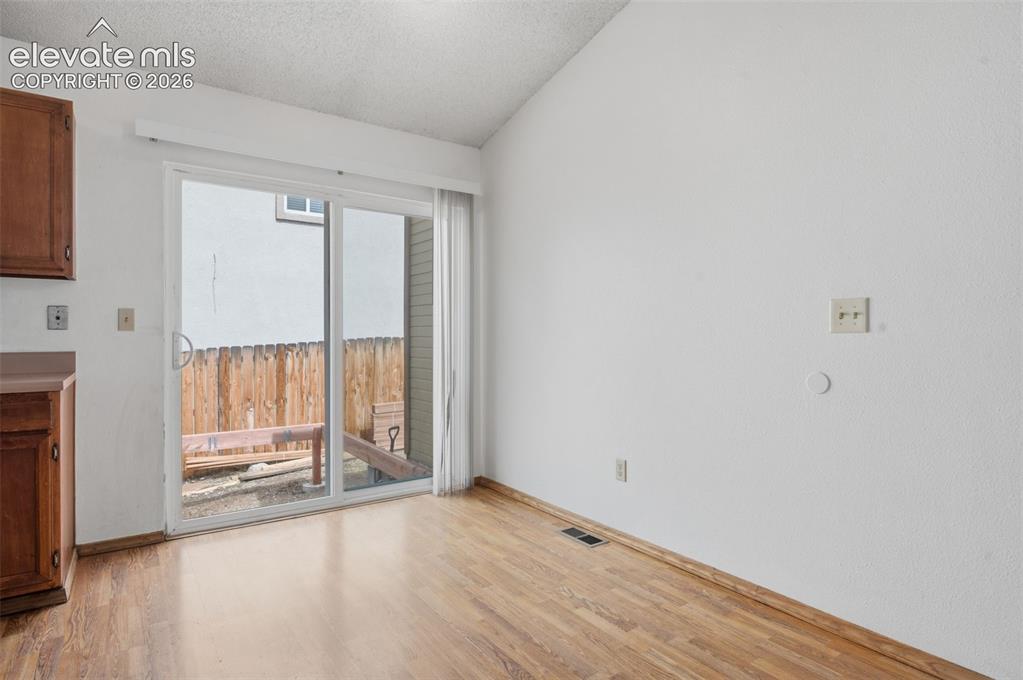 Image 6 of 29: Sliding glass door to new wood deck.