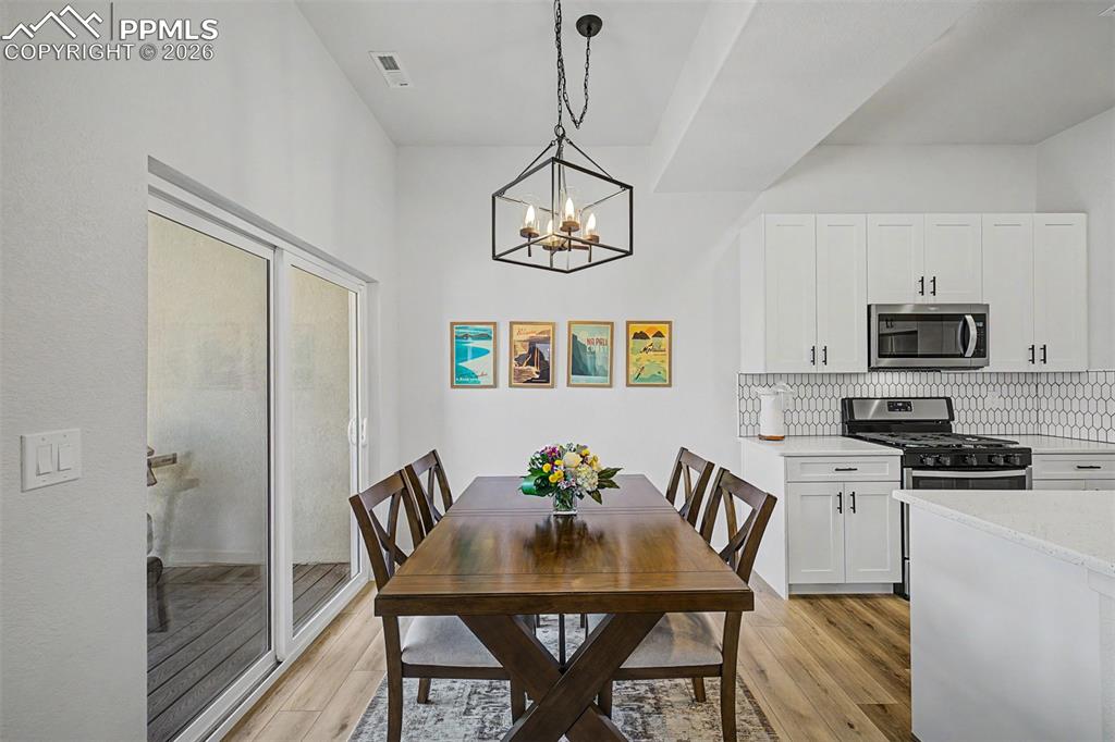 Image 10 of 39: The dining area feels effortlessly connected to the outdoors, with a slidin