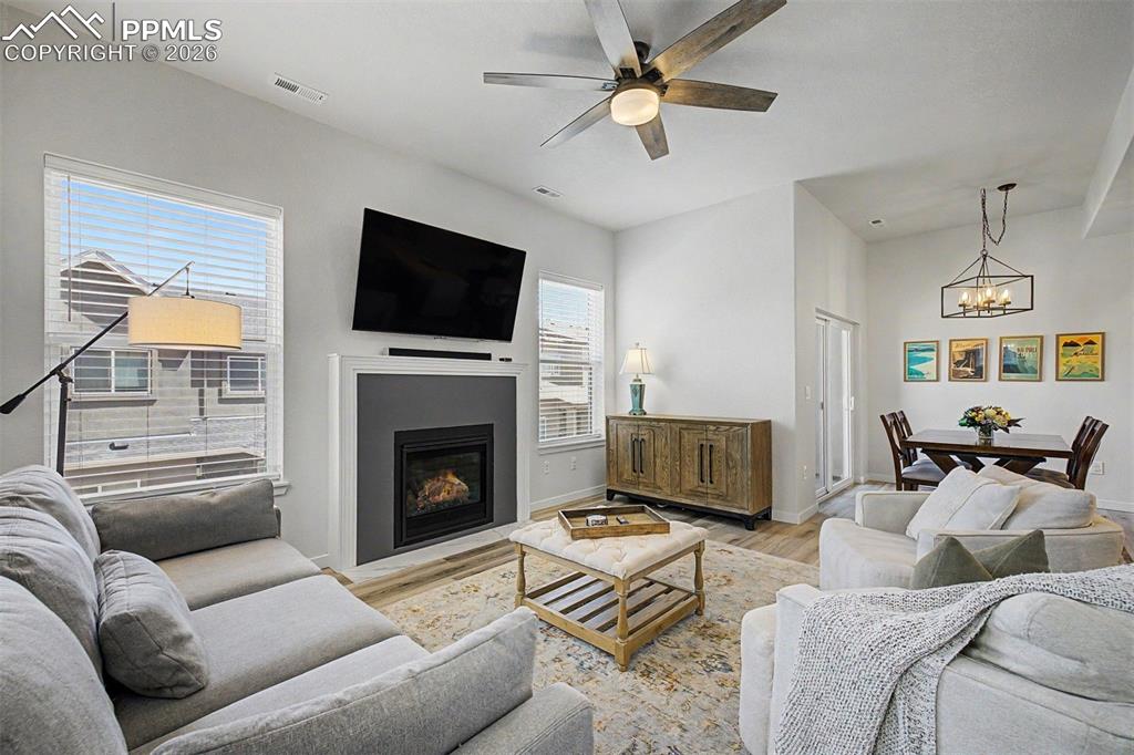 Image 13 of 39: The gas fireplace is a showpiece on its own — framed in a crisp white mante