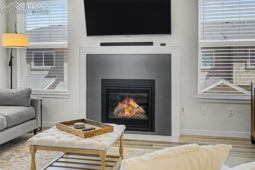 Image 15 of 39: Up close, the gas fireplace reveals its quality — real flame behind mesh sc