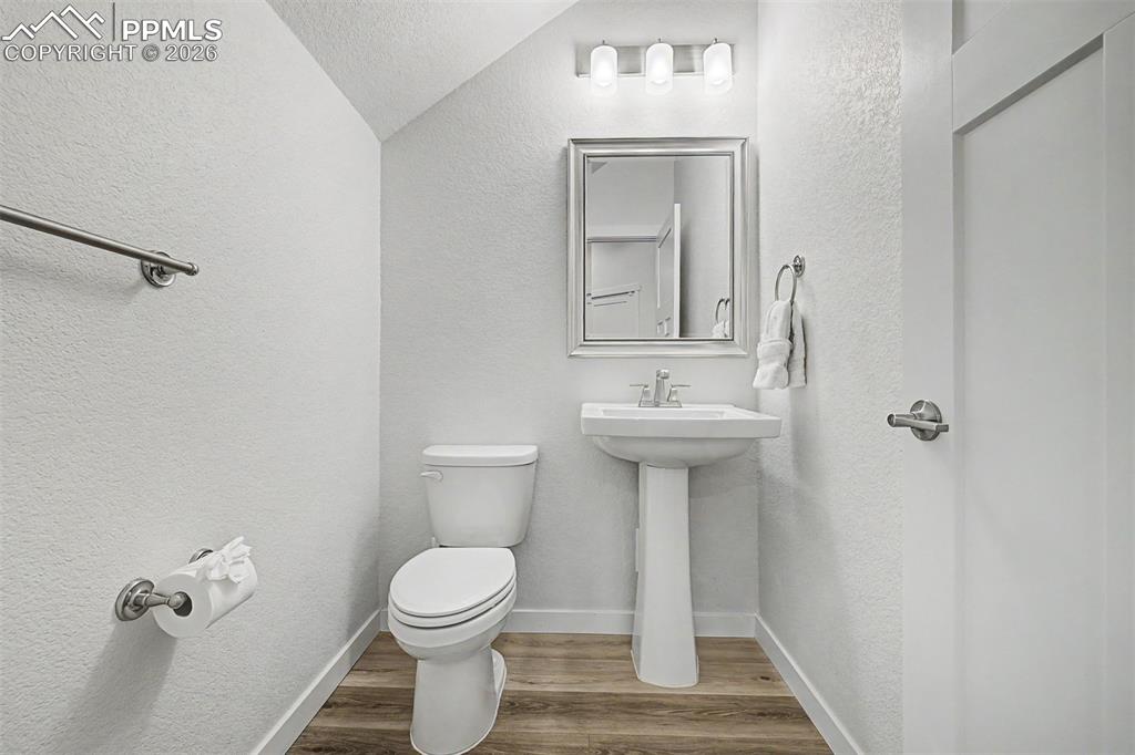 Image 16 of 39: Tucked conveniently on the main floor, the powder bath is clean and classic
