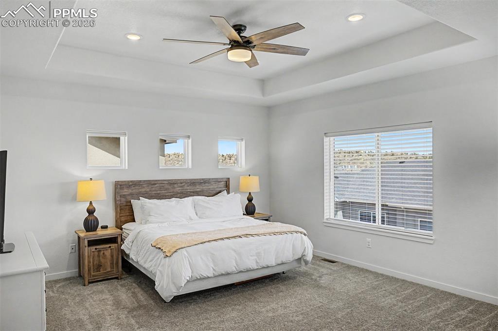 Image 17 of 39: The primary suite is a genuine retreat — spacious and serene, with a tray c