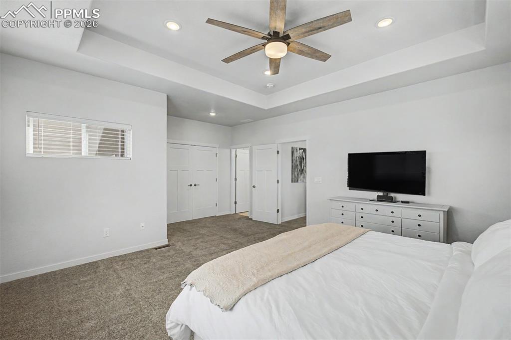 Image 19 of 39: The tray ceiling adds a quiet architectural elegance to the primary suite,