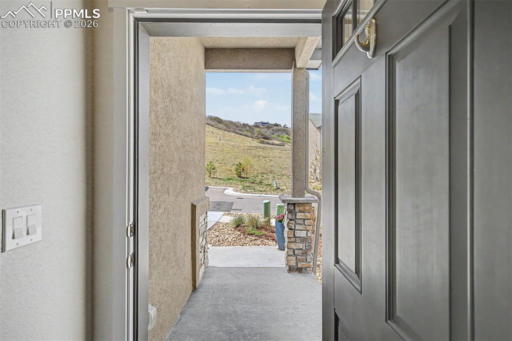 Image 3 of 39: Step inside and look back — a peaceful hillside landscape stretches into th