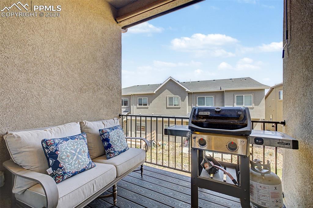 Image 32 of 39: The back balcony is outfitted for real outdoor living make this covered spa