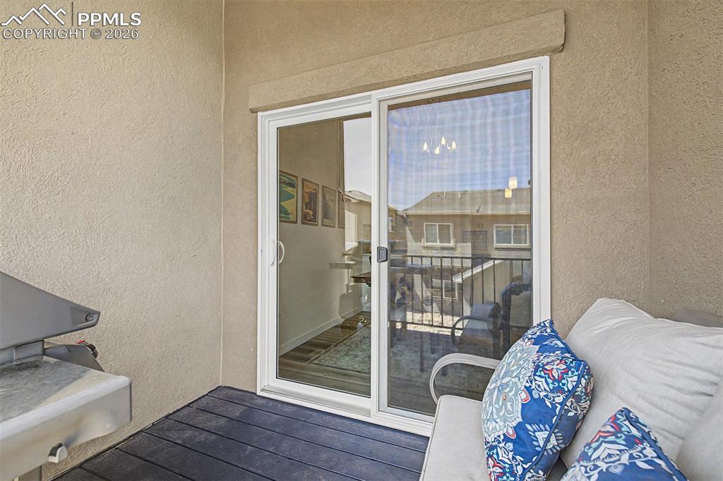 Image 33 of 39: The sliding glass door from the dining area opens onto the back deck, blurr