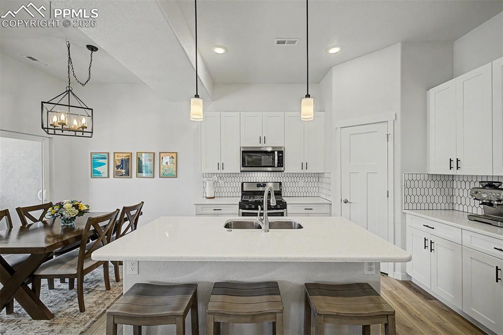 Image 6 of 39: The oversized quartz island is the kitchen