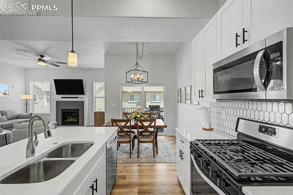 Image 7 of 39: From behind the gas range, the entire entertaining space unfolds in a singl