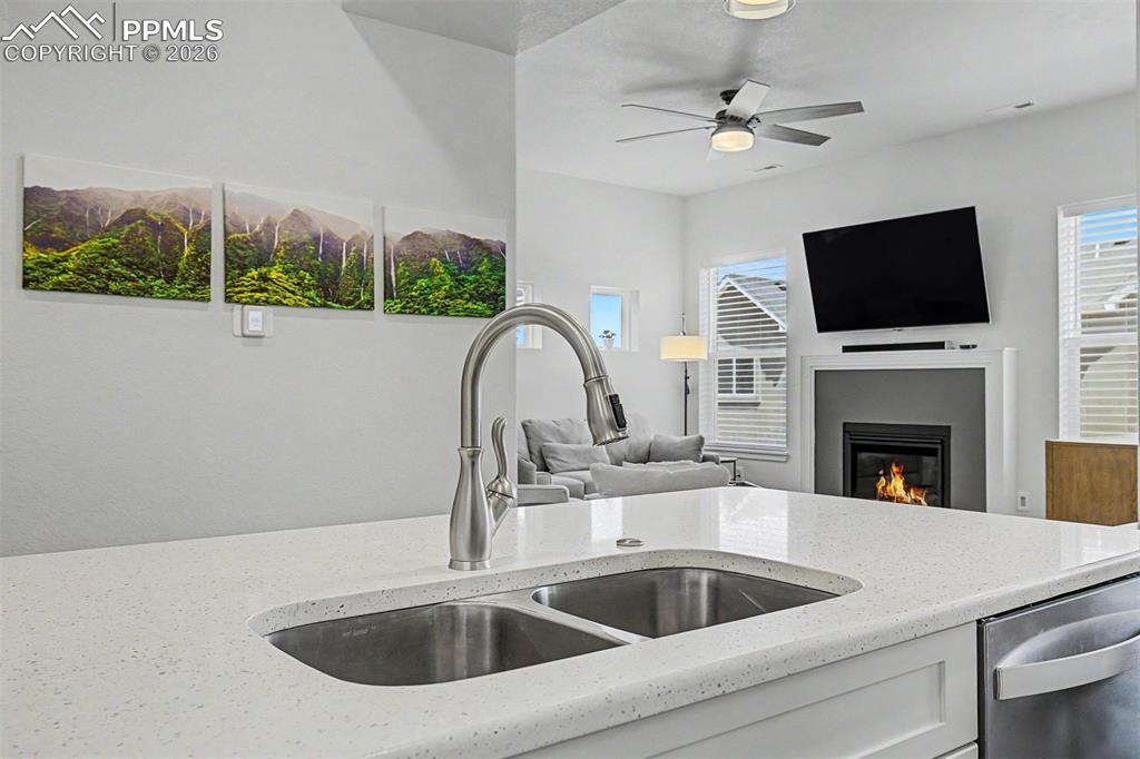 Image 8 of 39: At the island sink, the view extends all the way into the living room, wher