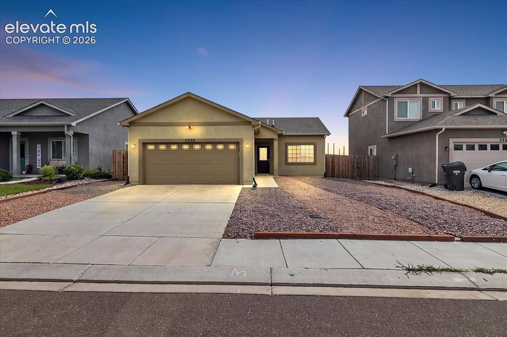 Image 1 of 36: Single-story residence featuring a two-car garage with transom windows, a c