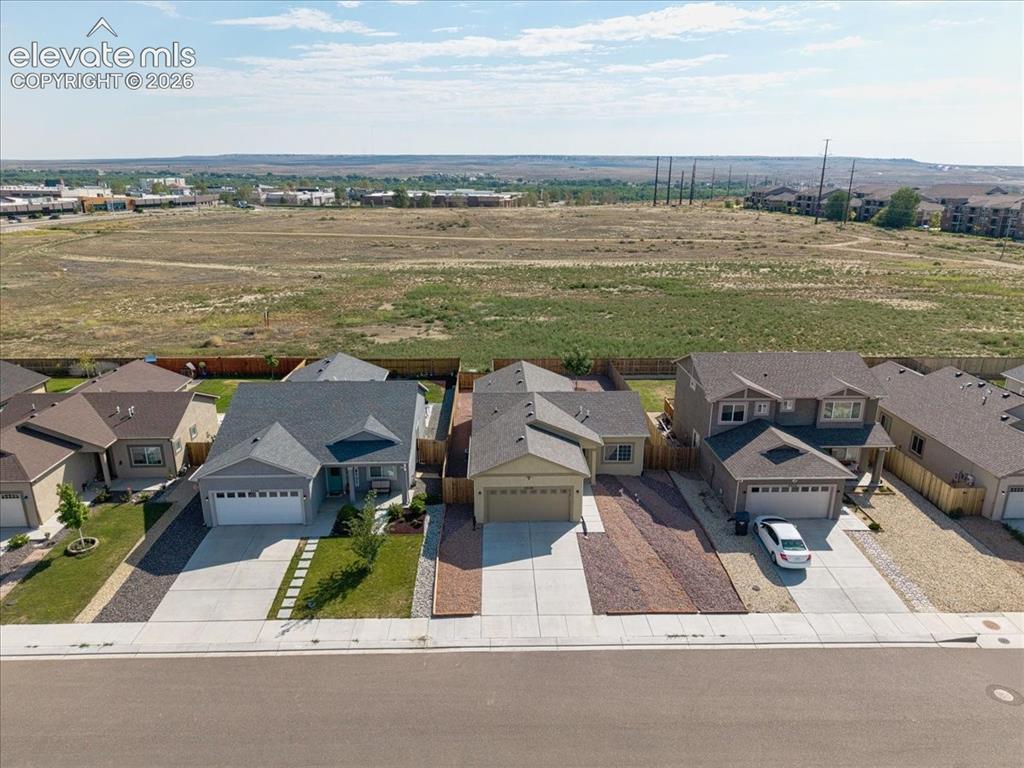 Image 27 of 36: Single-story residence featuring a gray exterior and an attached two-car ga