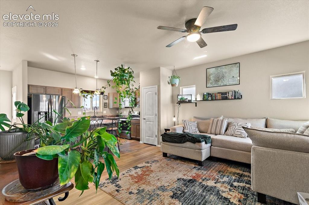 Image 3 of 36: Wood-finish flooring throughout, ceiling fan with integrated lighting, rece